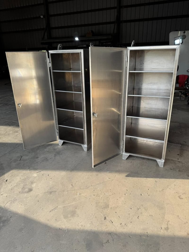 Pair of shelved aluminum cabinets with doors open