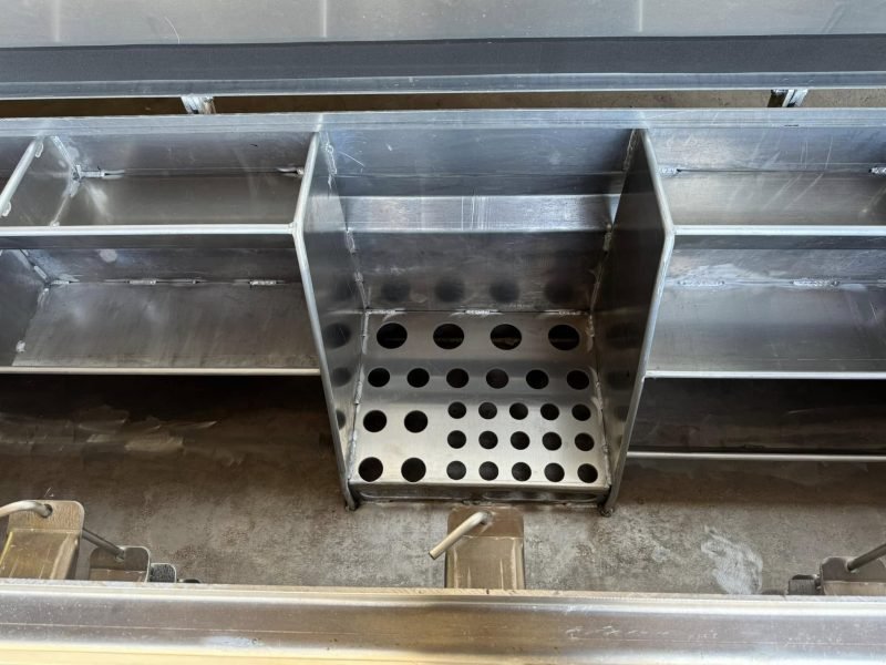 Interior of an aluminum toolbox with a perforated tray