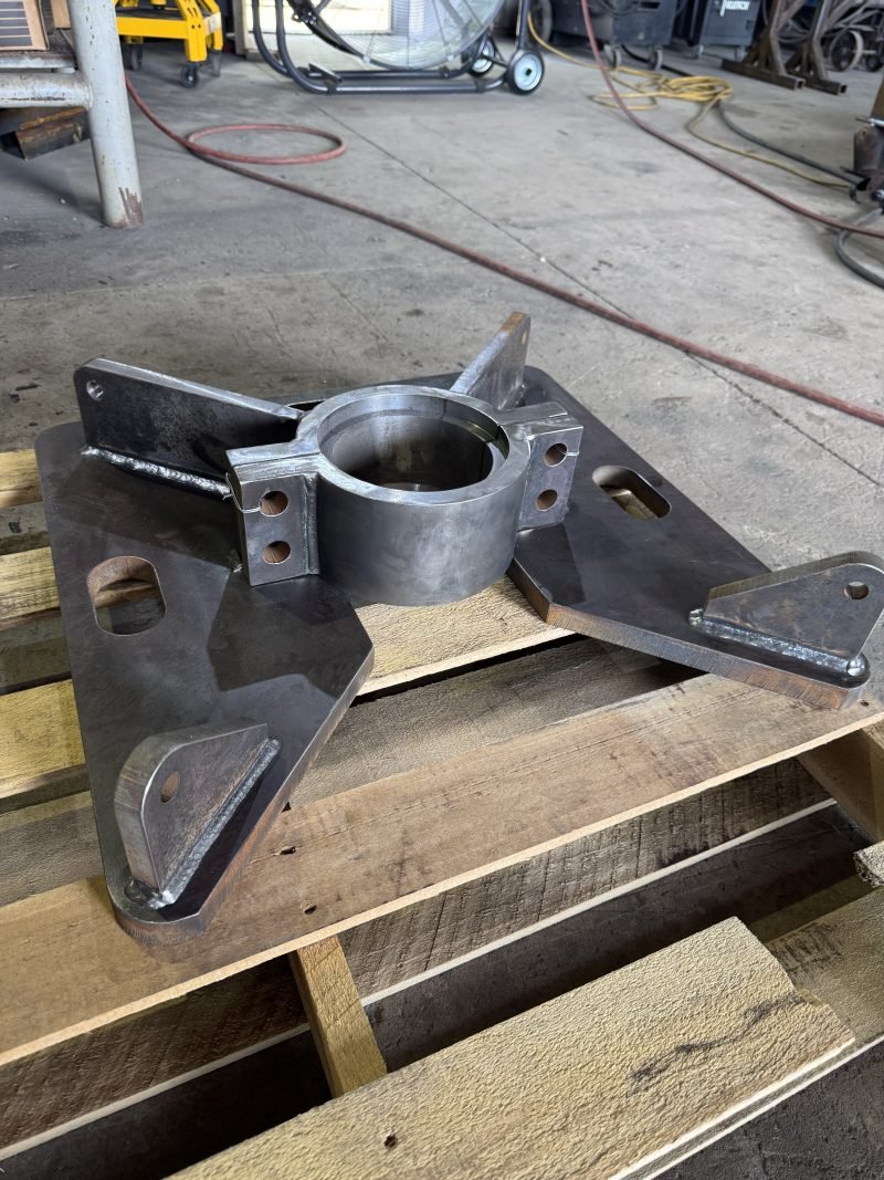 Close view of a pipe stub welded through a cut steel plate