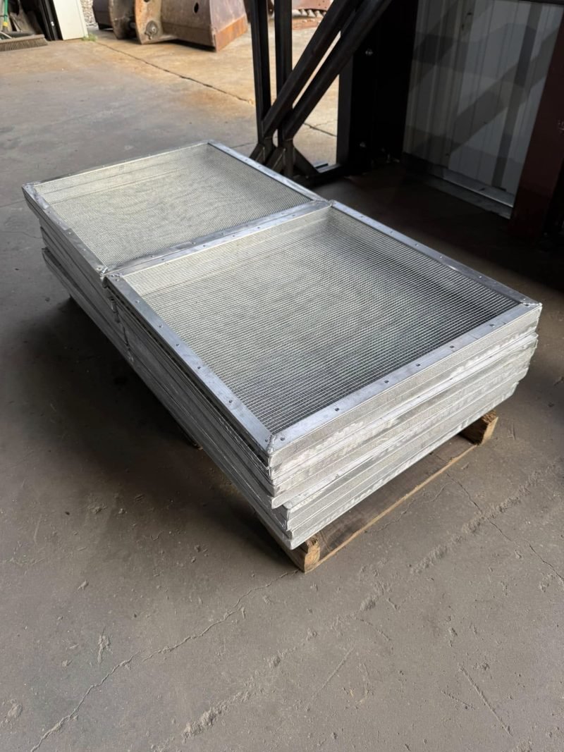 Stacked aluminum grating panels on a pallet