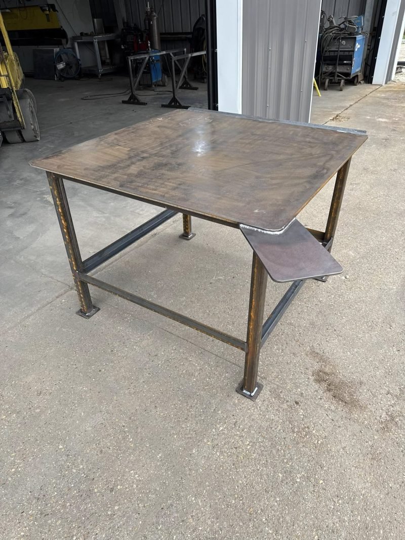 Steel work table with a small side shelf